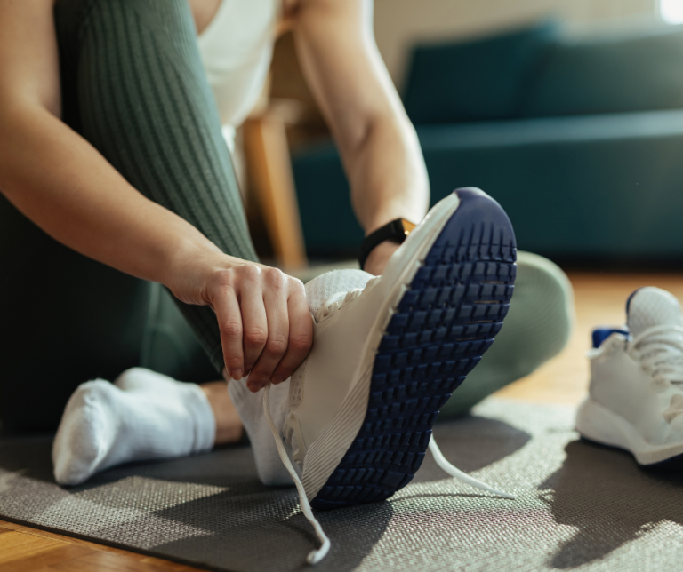 woman taking off shoe
